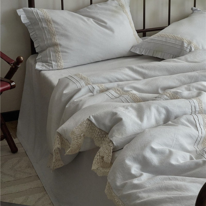 High-quality linen bedding set with handcrafted crochet lace, box pleats, and integrated bed skirt