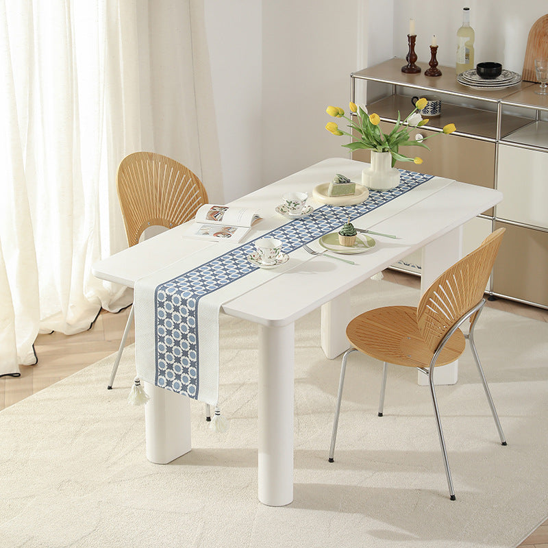 Web table runner made of cotton blend with woven diamond design and tassels