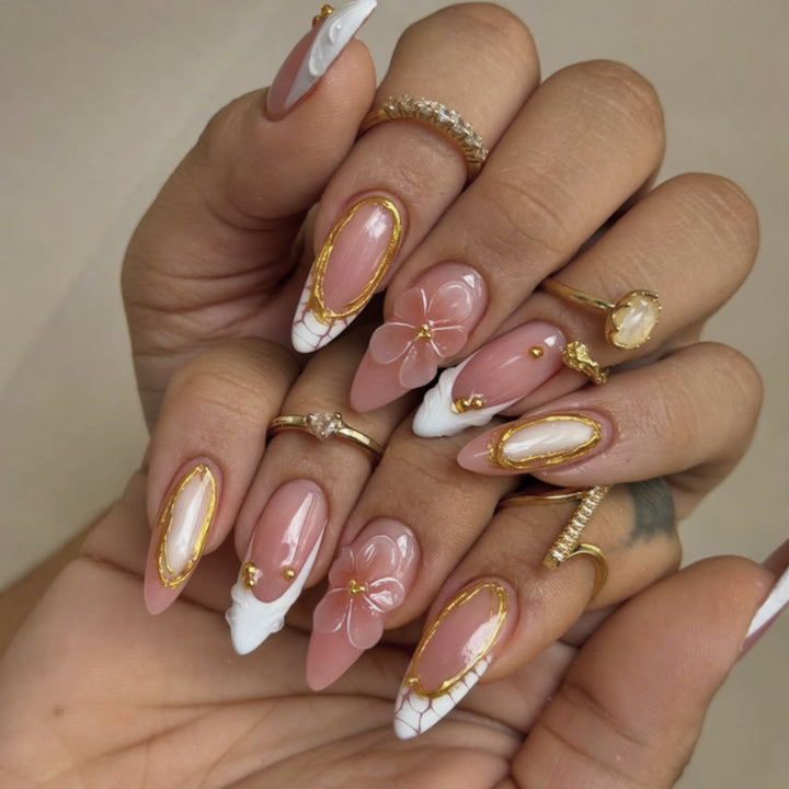 Artful nail art with floral and golden accents Kalsten