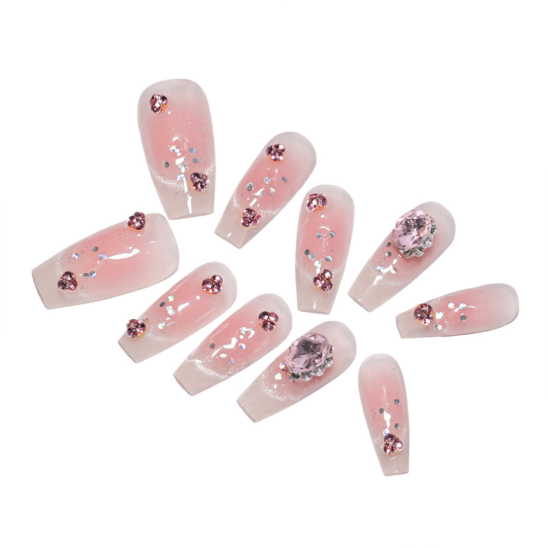 Artificial nail extensions with artistic glitter accents Kalsten