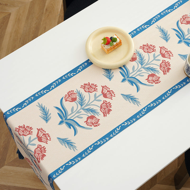 Table runner made of linen blend with floral block print motifs and tassels