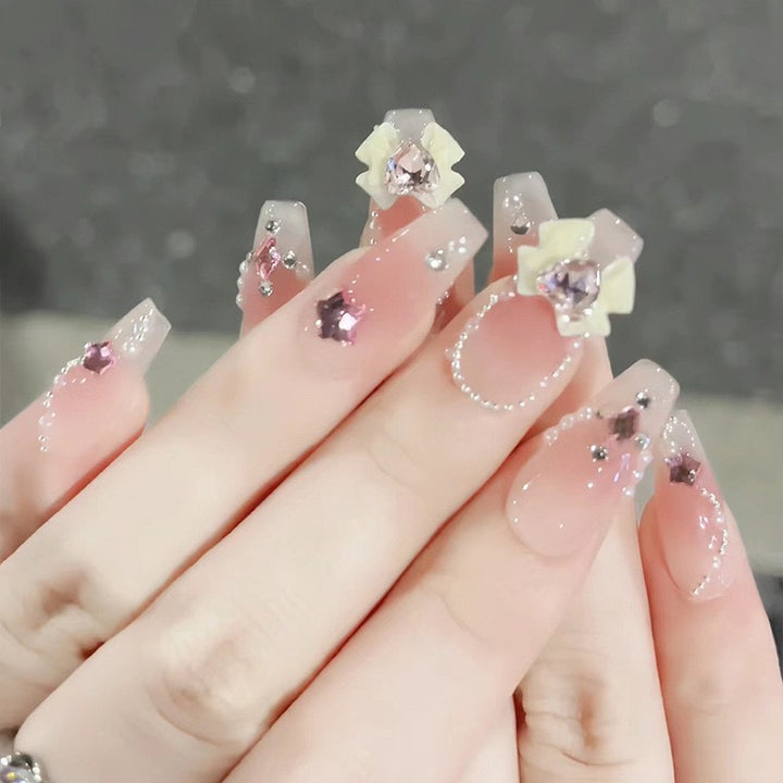 Artificial nails with glitter accents and playful motifs Kalsten