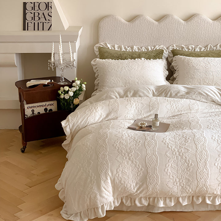 Quilted bedding set with ruffled hem and tone-on-tone embroidery