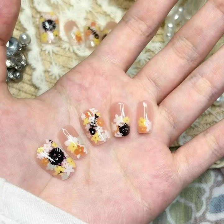 Playful artificial nails with cute animal motifs and floral accents Kalsten
