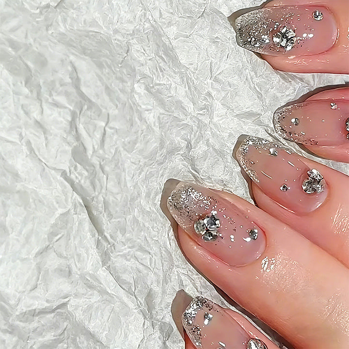 Glamorous artificial nails with glitter and rhinestone embellishments Kalsten