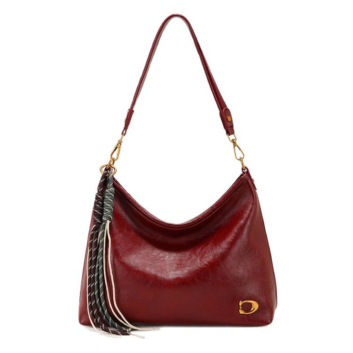 Elegant Hobo Handbag with Decorative Tassels