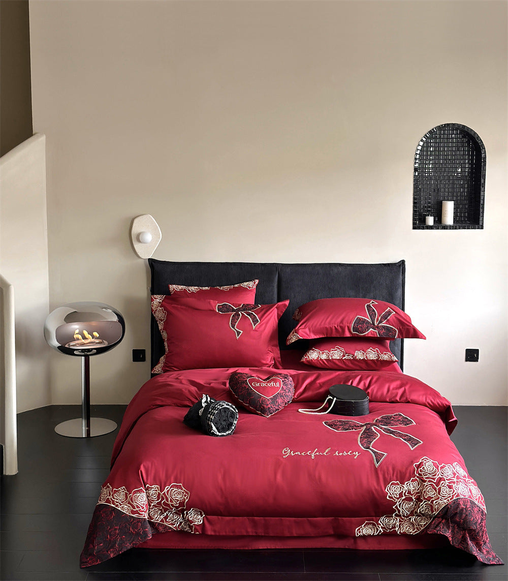 Luxurious satin bedding set with embroidered rose and bow motif