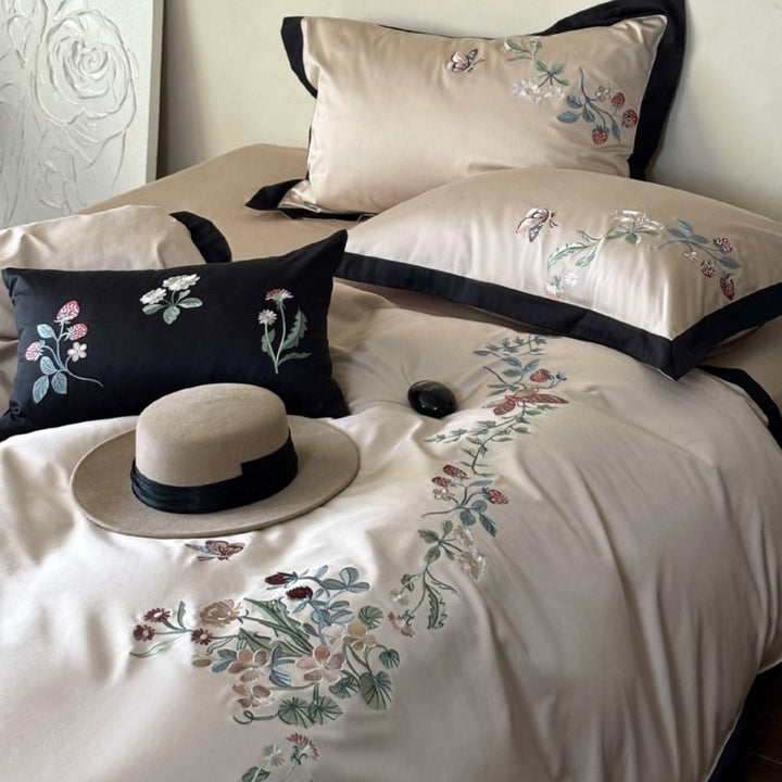 Luxurious embroidered satin bedding set with contrast piping and decorative pillow