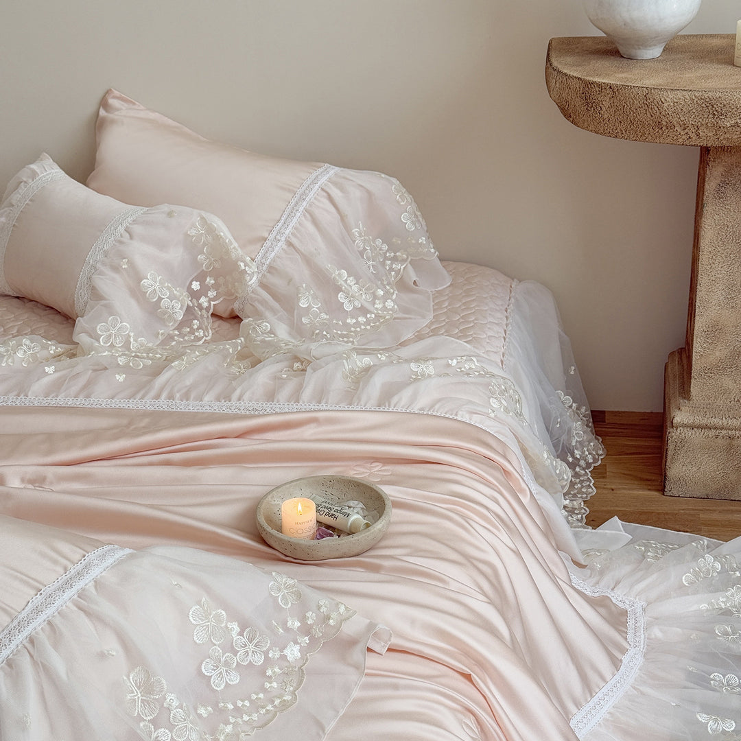 Satin bed linen set with embroidered chiffon ruffle and quilted bedspread