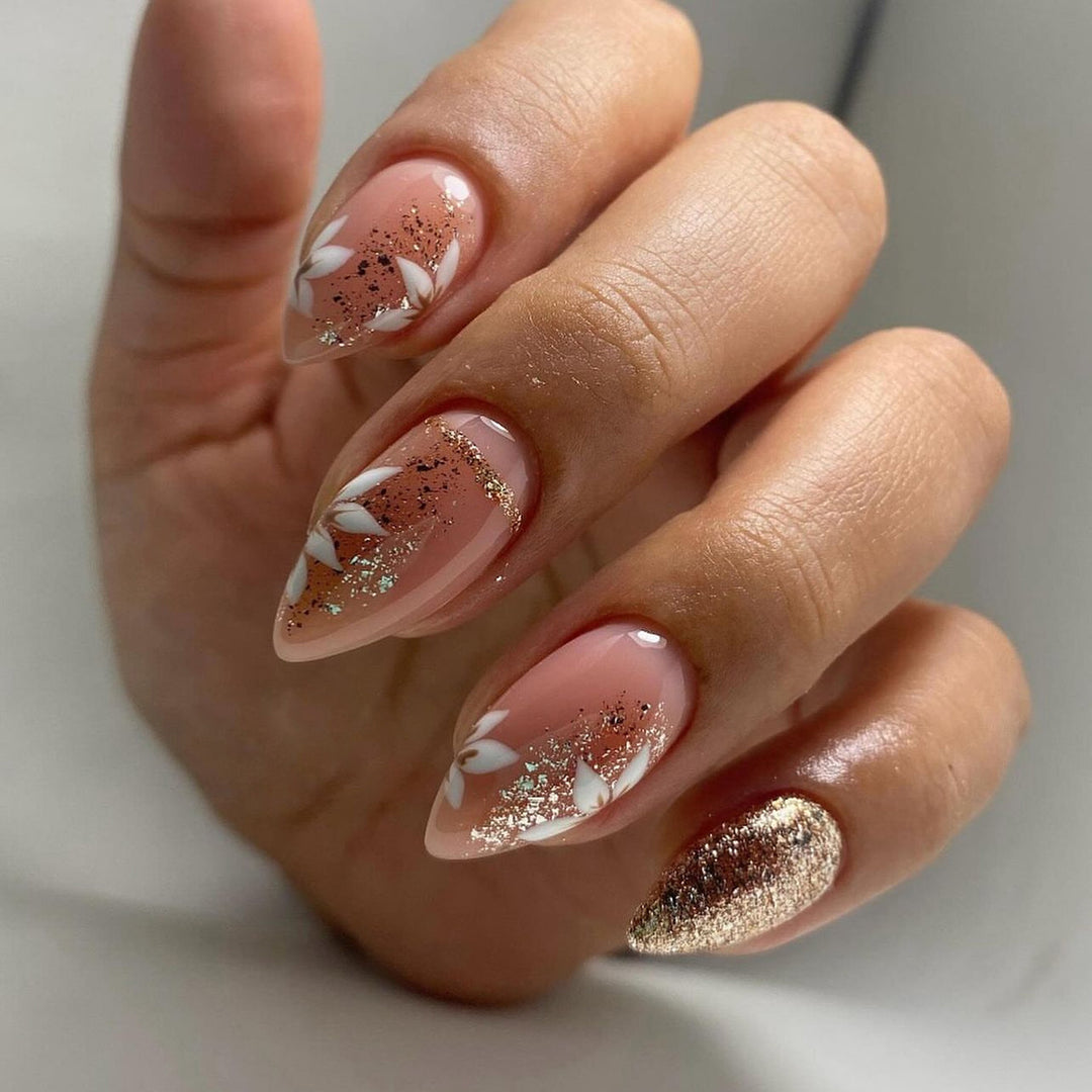 Artistic nail art with floral and glittering accents Kalsten