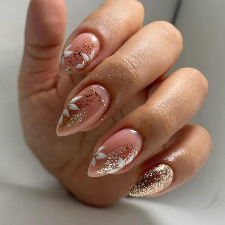 Artistic nail art with floral and glittering accents Kalsten
