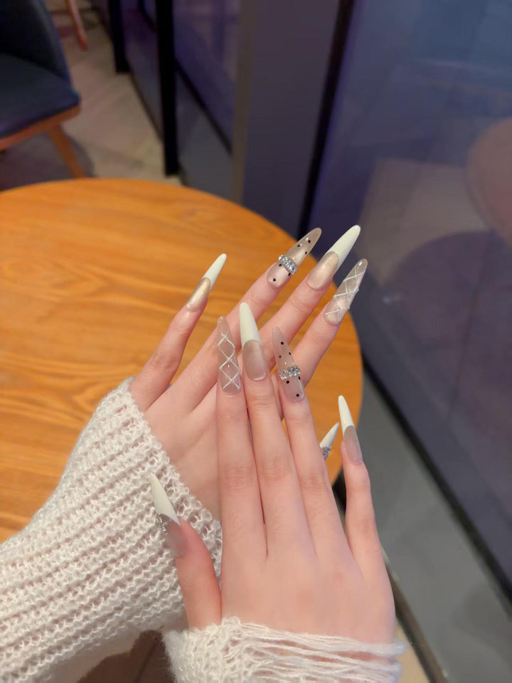 Elegant Stiletto Nail Extensions with Decorative Designs