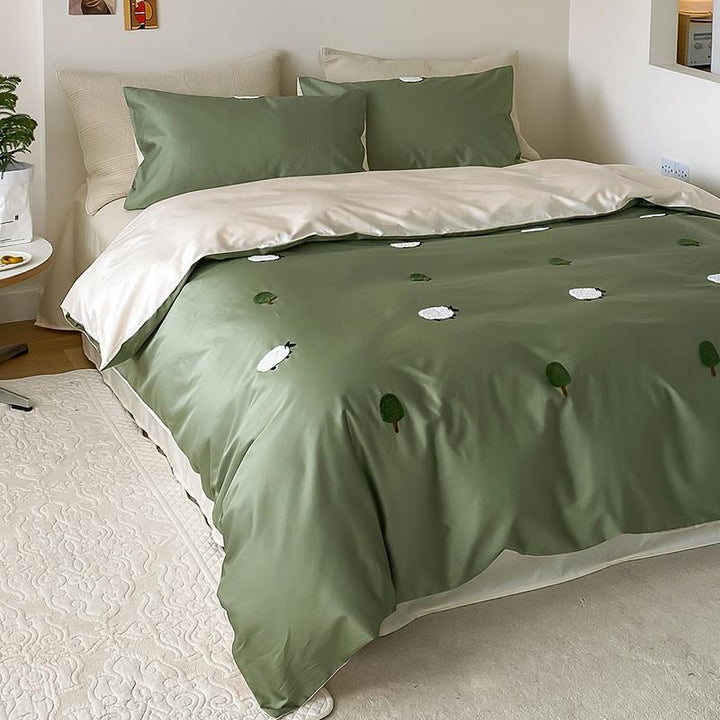 Reversible cotton satin duvet cover set with embroidered sheep and tree appliqués