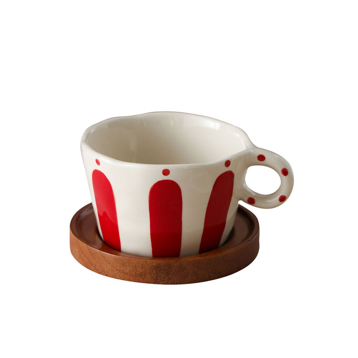 Ceramic espresso cup with round wooden coaster and handcrafted stripe pattern