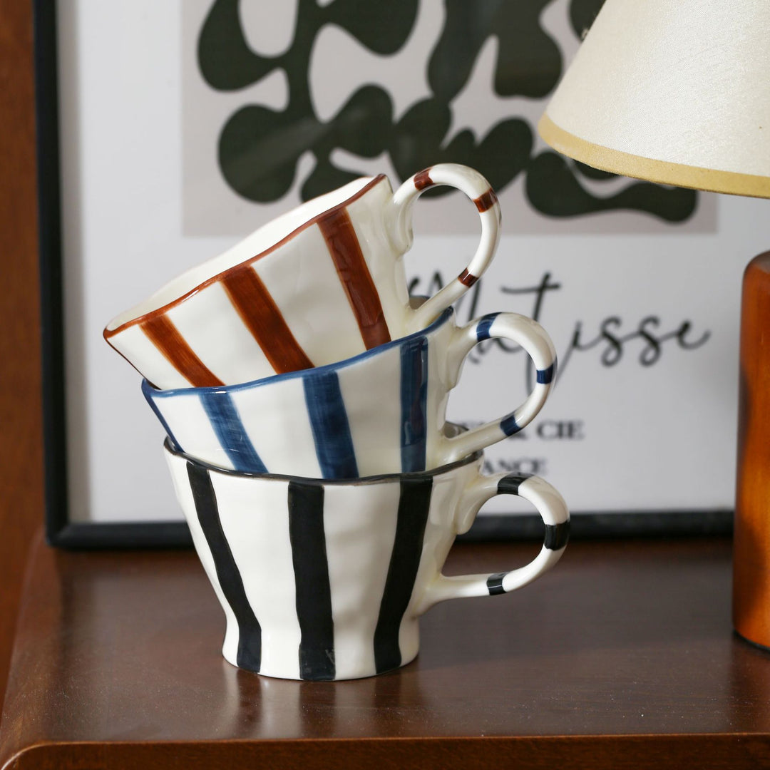 Designer stoneware coffee mug with scalloped rim and vertical brushstroke