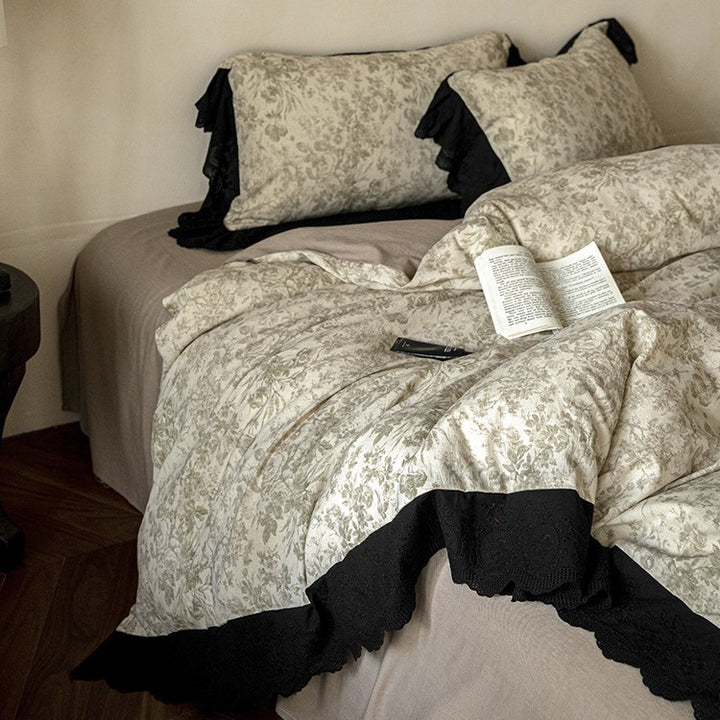 Bedding set with floral toile design and decorative lace trim