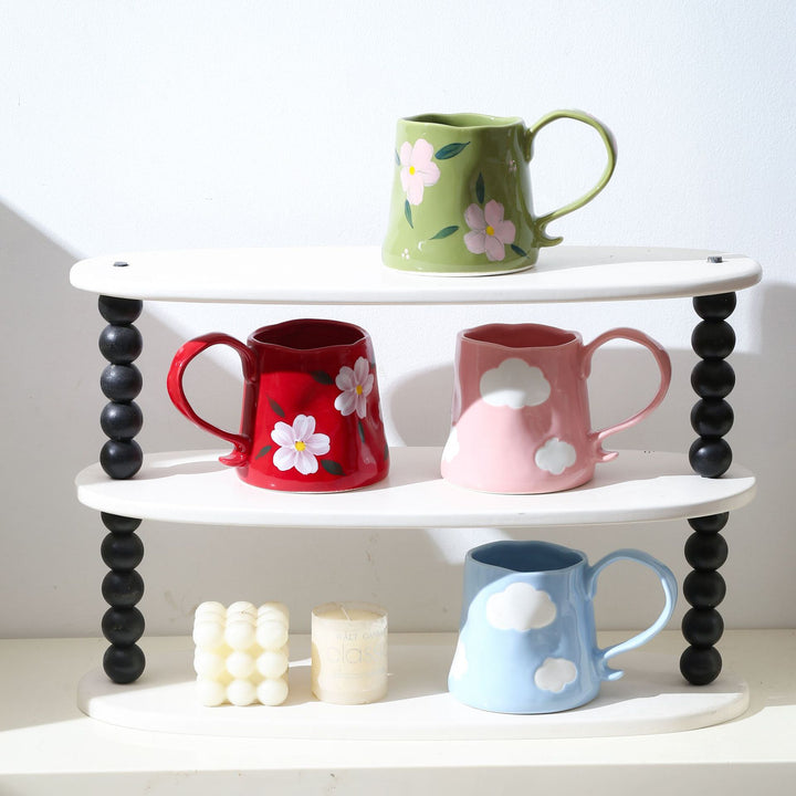 Hand-shaped ceramic mug with cloud relief and organic edge