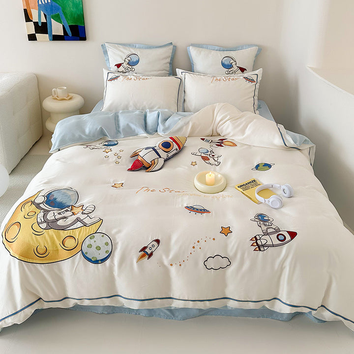 Children's bedding set with embroidered doll appliqués, ruffle and cuddle pillow