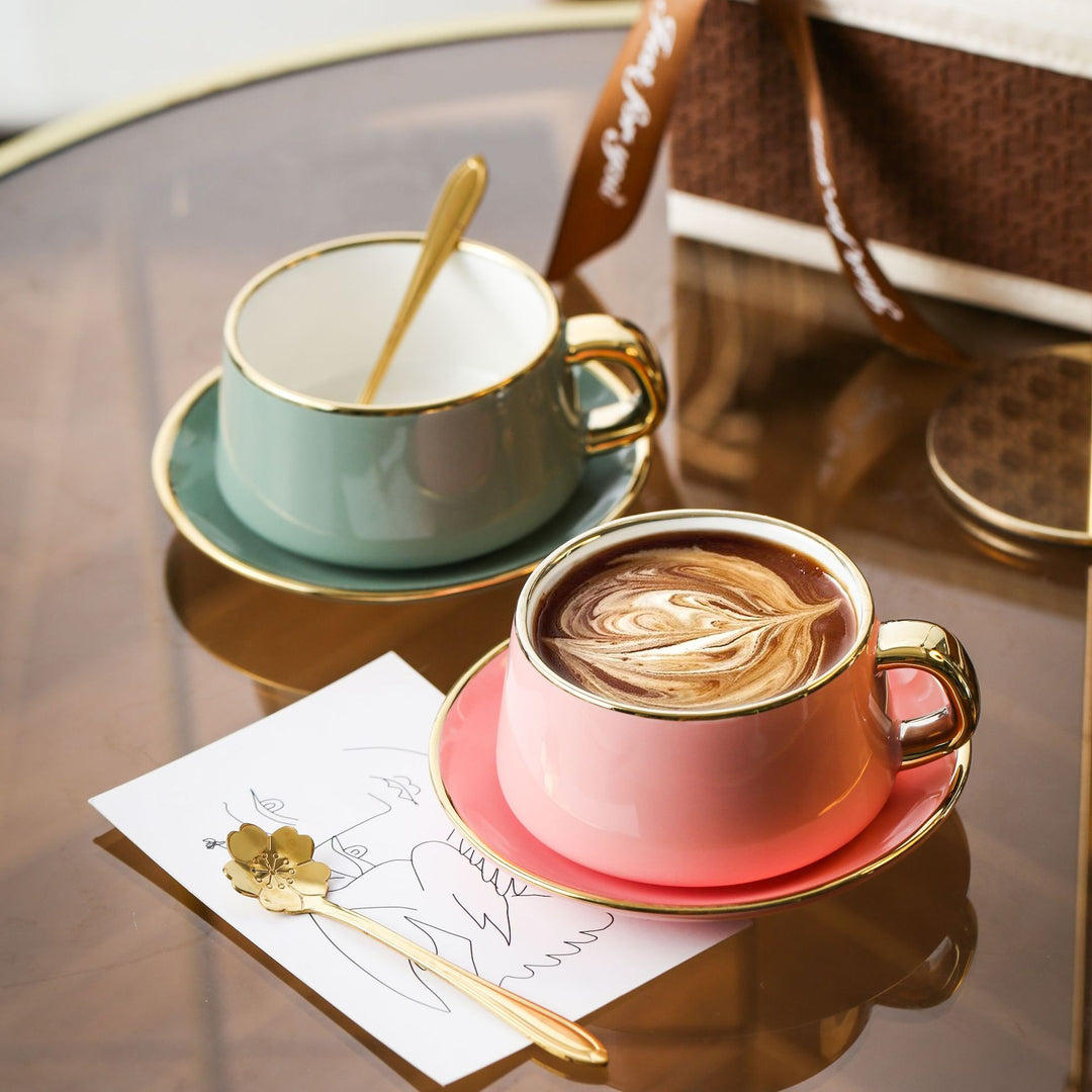 Elegant porcelain cup with saucer and sculptural gold handle