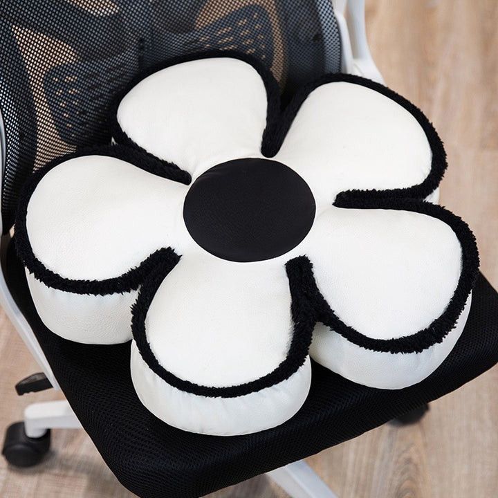 Padded seat cushion in flower shape with faux leather center piece and fluffy edge padding