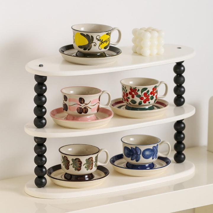 Ceramic coffee cup set with saucer and hand-painted leaf ornament