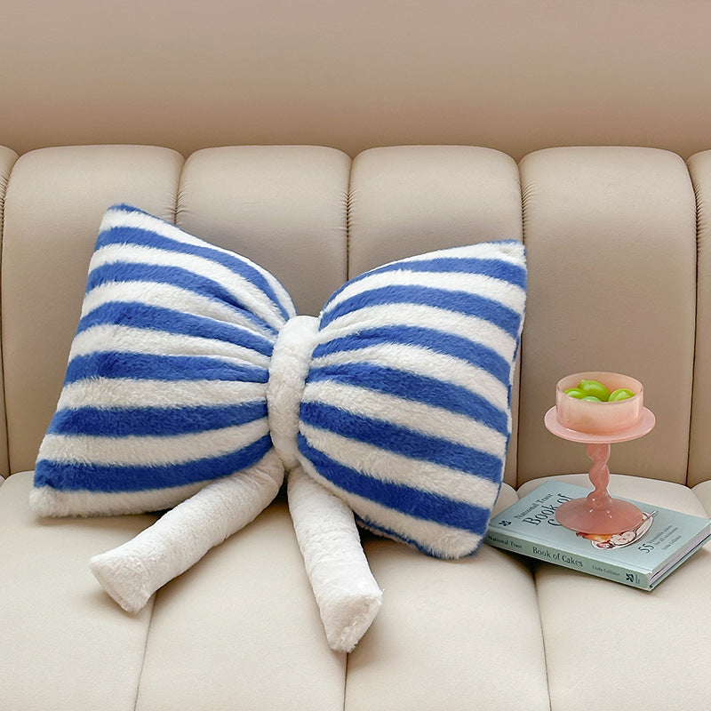 Cuddle cushion in bow shape made of plush with striped texture
