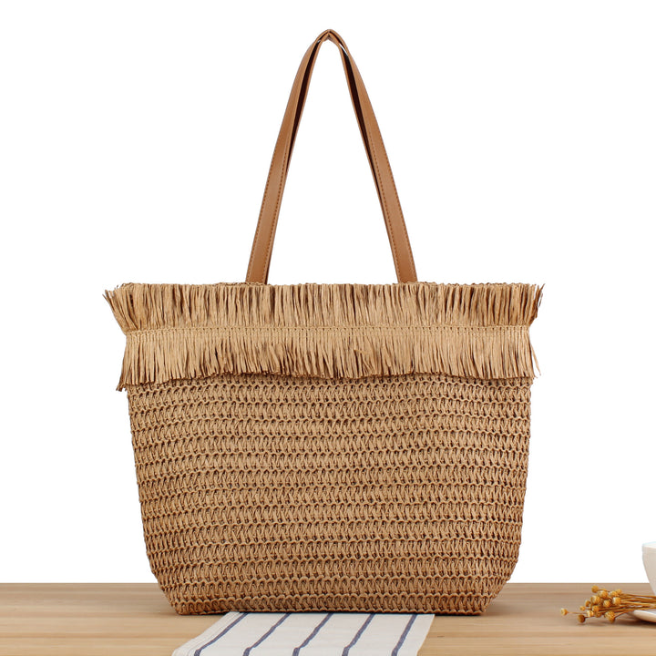 Beach bag made of handwoven natural material with fringe decoration Kalsten
