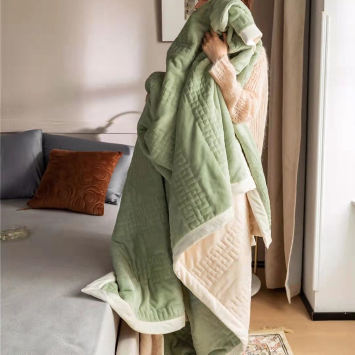 Reversible quilted comforter with structured box stitching and cotton trim