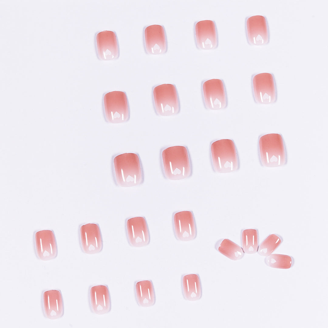 Artful nail art with heart-shaped accents and gentle ombre effect Kalsten