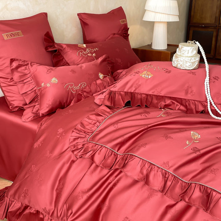 Romantic satin bedding set with ruffles, fine floral embroidery, and reversible pillowcase