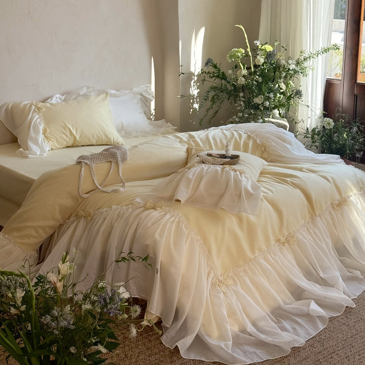 Bedding set with ruffled bed skirt, ruffle cushion and bow application