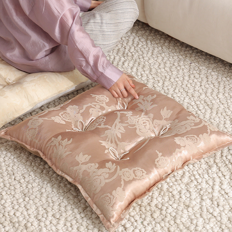 Padded floor cushion with quilted tufting and tassels