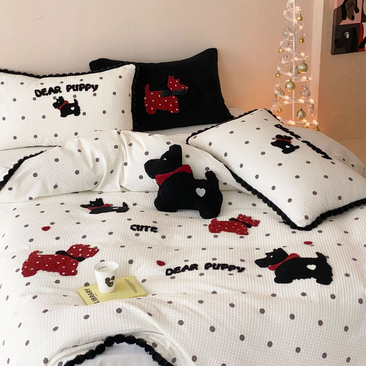 Quilted bedspread and pillow set with embroidered puppy motifs