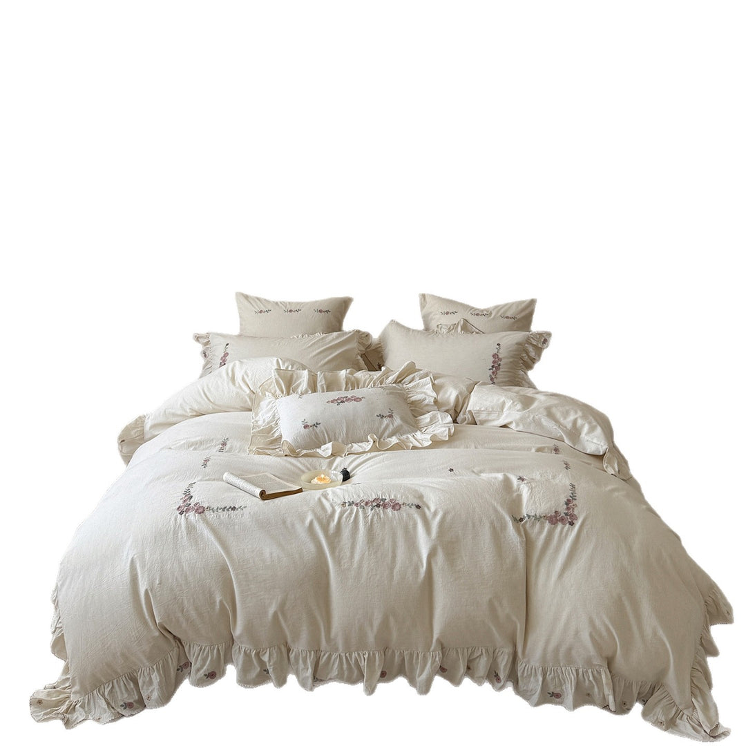 Bedding set in natural linen style with delicate rose garland embroidery and ruffled trim