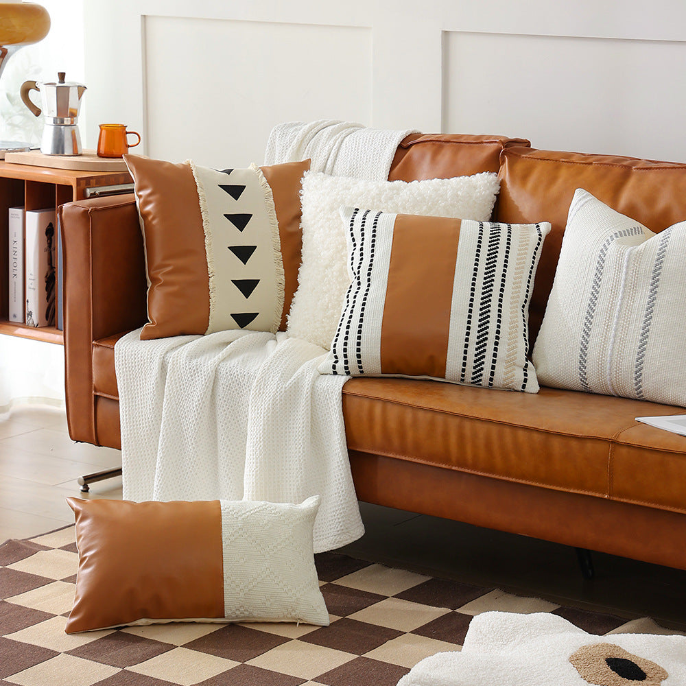 Square faux leather decorative cushion with woven central stripe and fringes