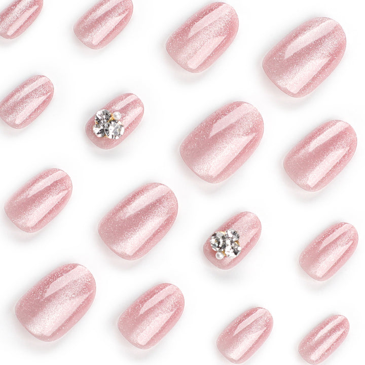Artful glitter nail extensions with elegant rhinestone accents Kalsten