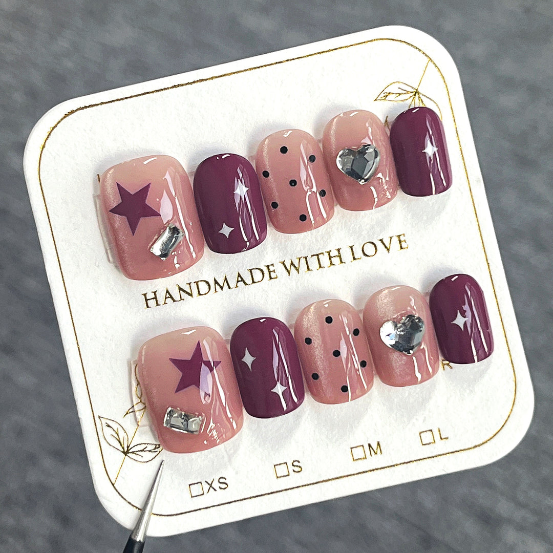 Artificial nail extensions with unique jewelry accents Kalsten