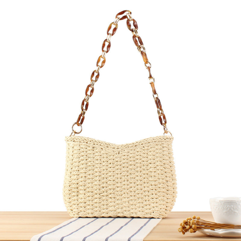 Stylish handbag made of woven natural material with exclusive chain accents Kalsten