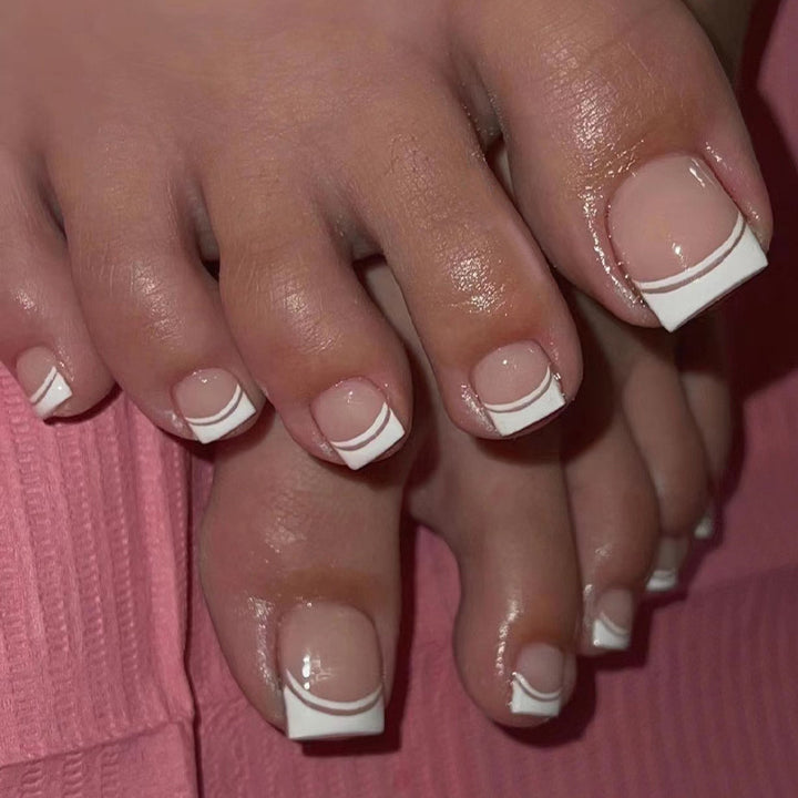 Artful toenail art with elegant French tip design Kalsten