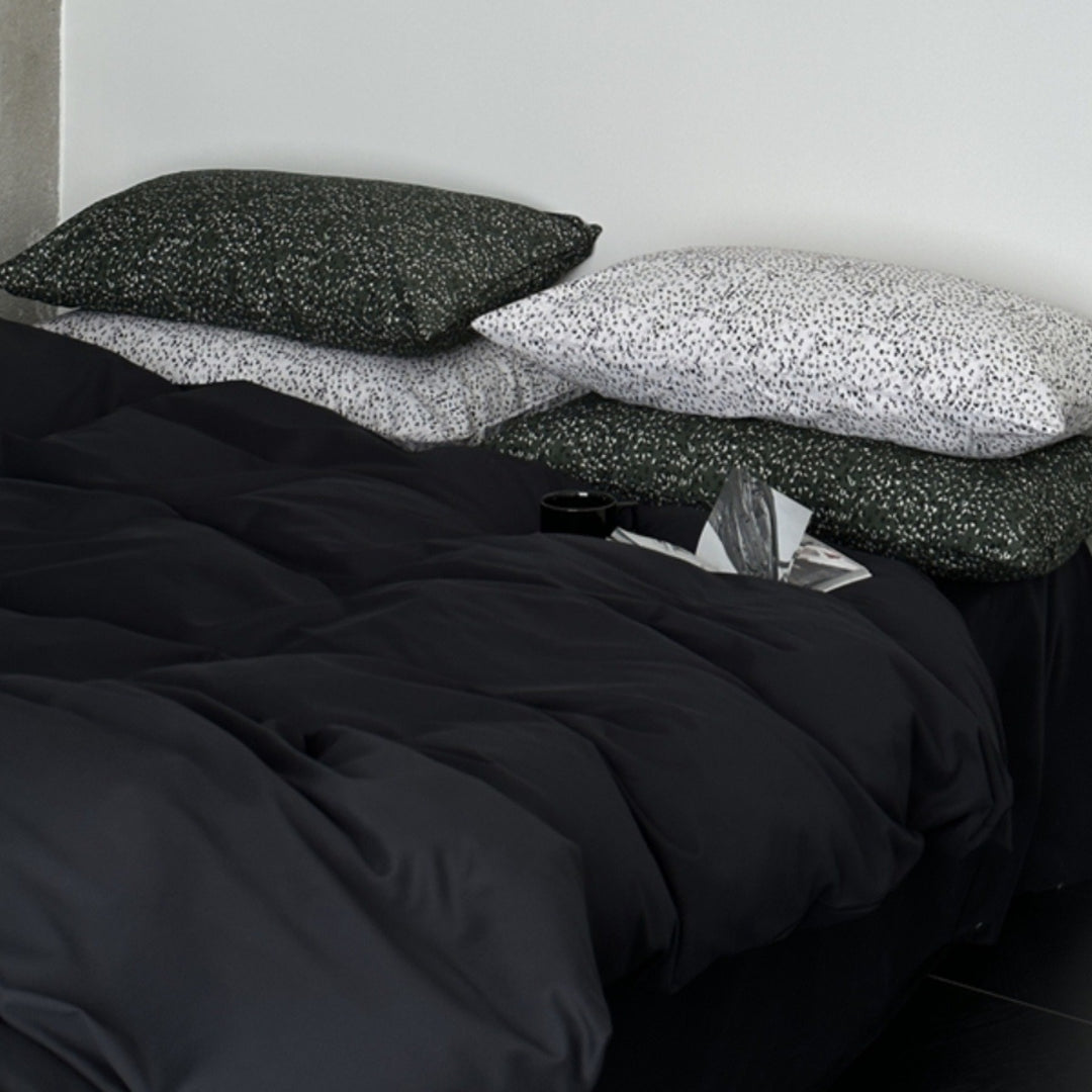 Modern satin bedding set with quilted look and patterned pillowcases