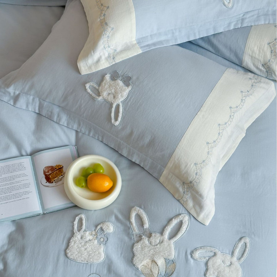 Embroidered cotton satin bedding set with appliquéd rabbit designs and decorative border
