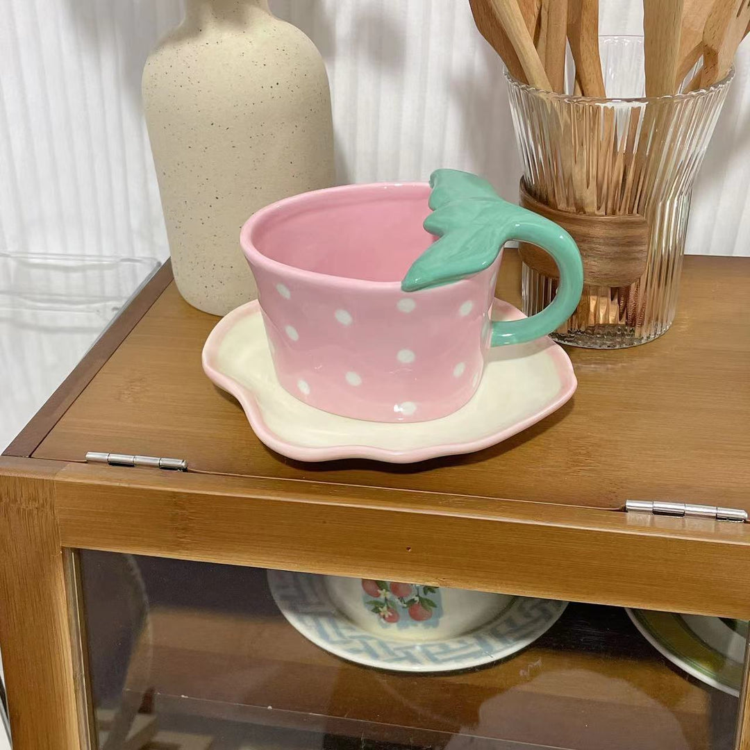 Playful ceramic mug with shaped leaf handle, saucer, and tulip spoon