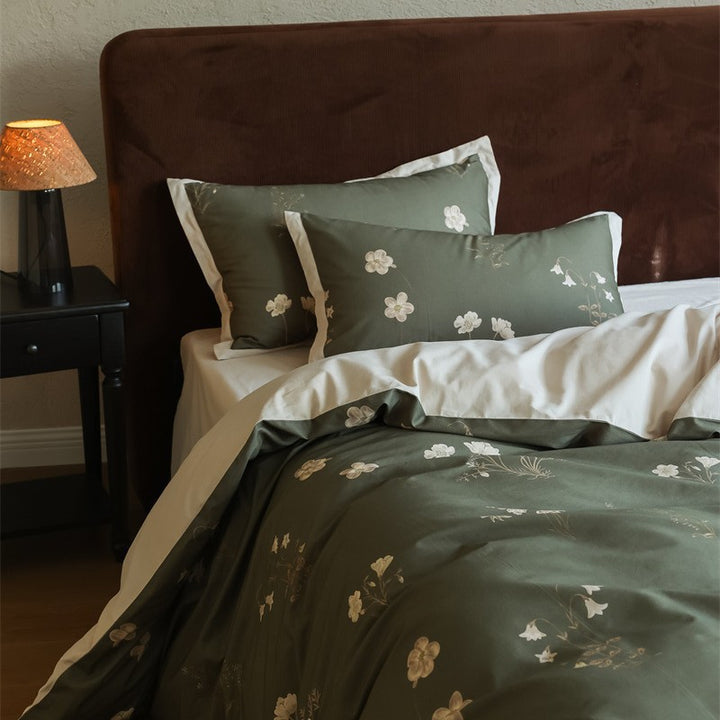 Cotton satin bedding set with subtle botanical print and contrasting hem edge