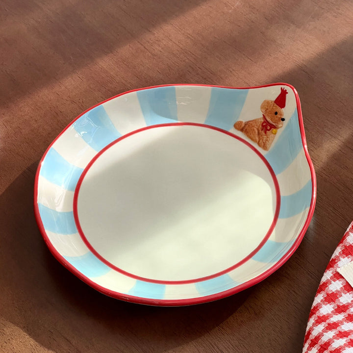 Decorative ceramic deep plate with pouring spout, striped rim and bear motif