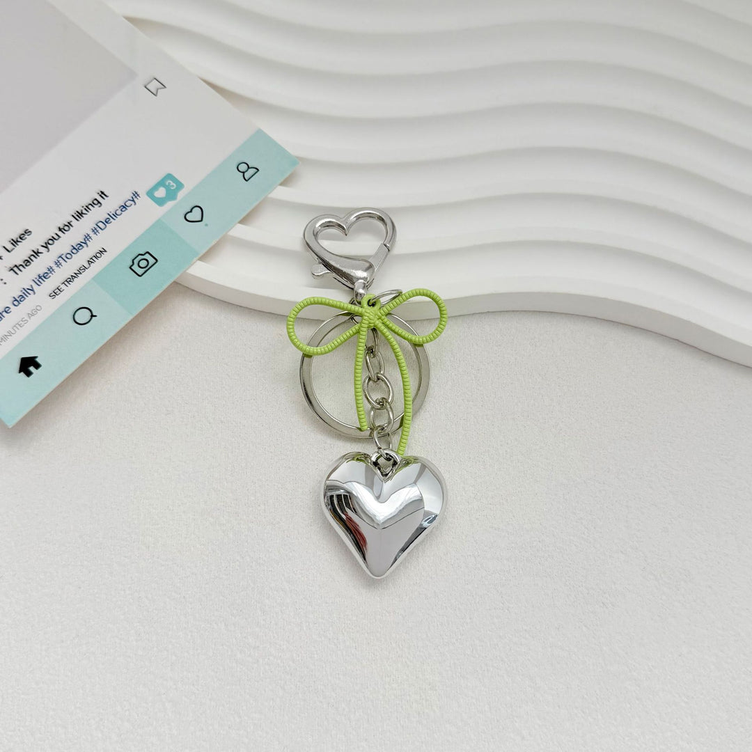 Heart-Shaped Metallic Keychain with Decorative Bow Kalsten