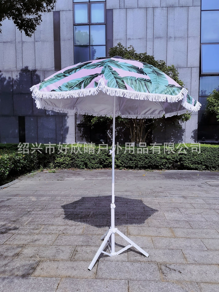 Ladies sun umbrella with tropical leaf design and tassel decoration Kalsten