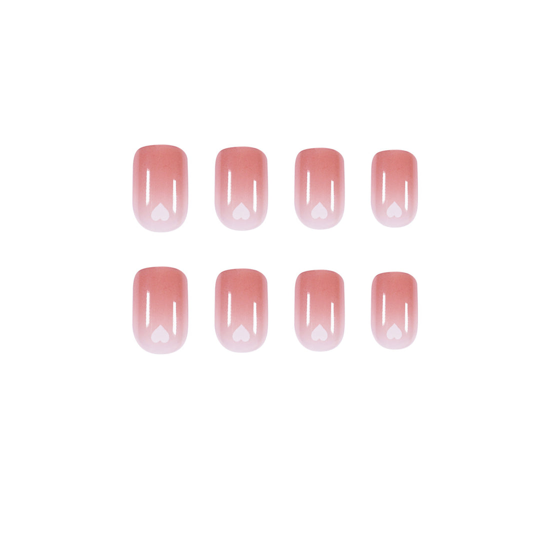 Artful nail art with heart-shaped accents and gentle ombre effect Kalsten