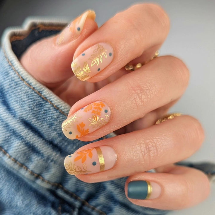Artistic nail design with floral and golden accent Kalsten