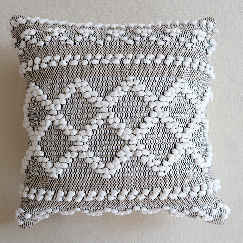 Square woven decorative cushion cover with crocheted appliqués and textured relief