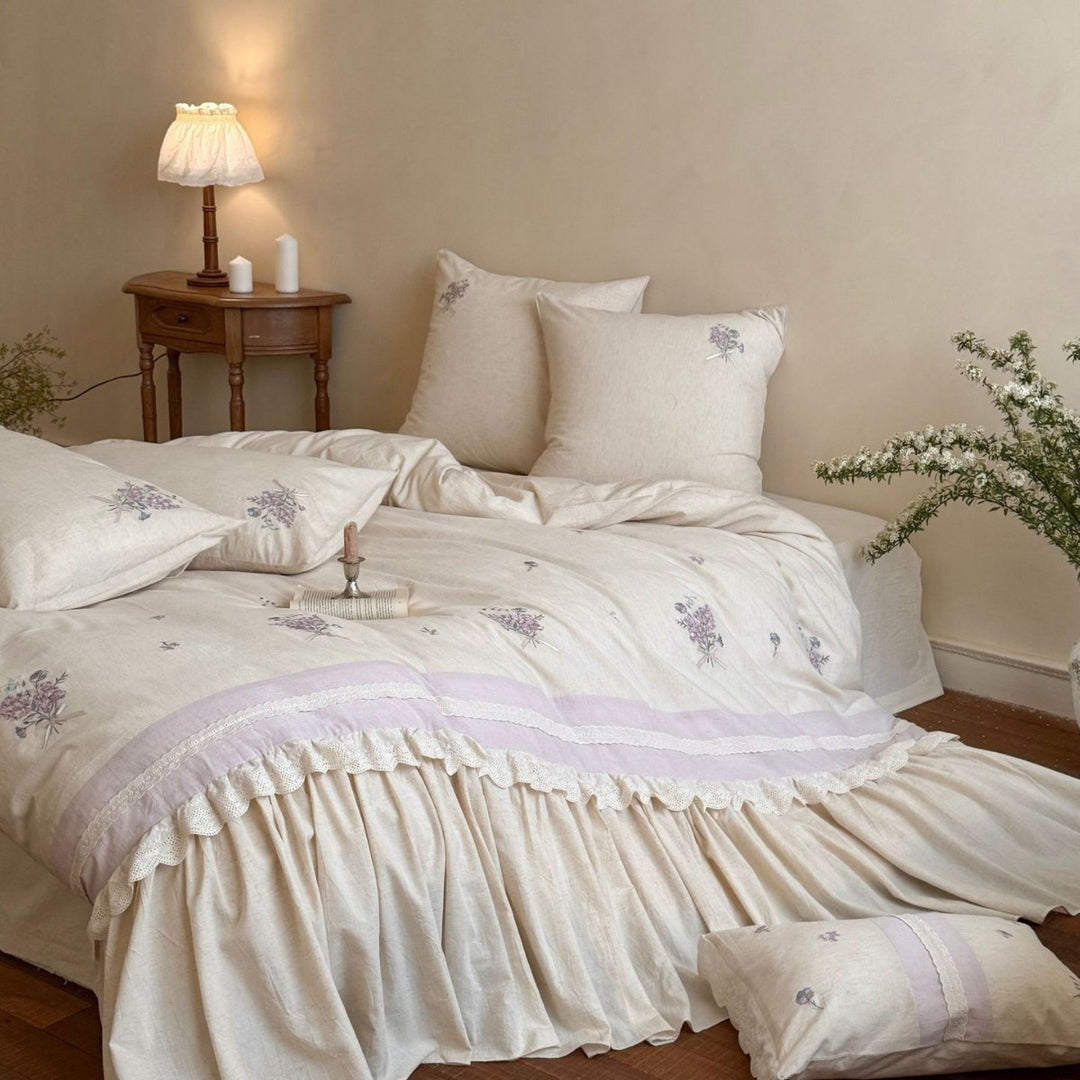 Vintage-inspired bedding set with ruffled bed skirt and delicate floral embroidery
